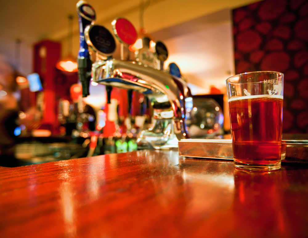 Pint of beer on a bar in a traditional style English pub