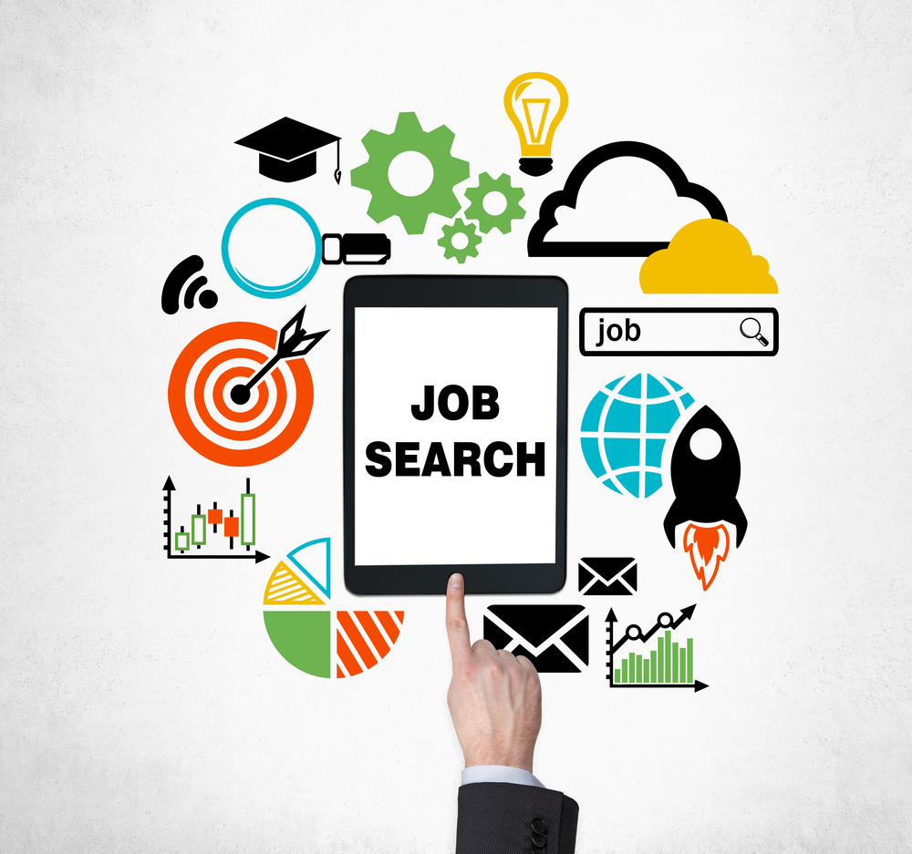 A finger is pushing the button on the tablet to find new job vacancies. Looking for a job in the Internet. The concept of searching job and technology. Internship and graduate programmes.